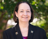 Portrait photo of Dr. Jeanne Van Briesen from the shoulders up.